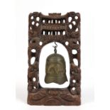 A Chinese bronze gong on carved hardwood frame decorated with dragons having glass inset eyes,