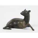 A Chinese patinated bronze model of a recumbent doe. Character marks to the underside, 15.5cm.