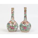 A pair of nineteenth century "clobbered" Cantonese bottle vases, 16cm. Condition Report. To be