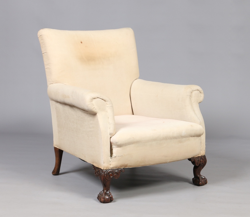 A nineteenth century upholstered armchair raised on carved ball and claw supports. Condition Report.