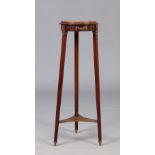 A Victorian mahogany leather topped torchere stand with gilt metal mounts and raised on splay reeded