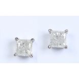 A pair of 14 carat white gold stud earrings each set with a square cut diamond of approximately 0.