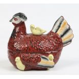A nineteenth century Staffordshire pottery egg basket. Coloured in enamels and formed as a hen and