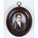 An early nineteenth century oval portrait miniature of a young gentleman. Condition Report. To be