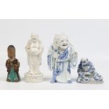 An antique Chinese blanc de chine figure of a Buddha raised on an ovoid plinth, two similar