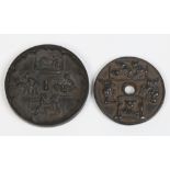 A Chinese bronzed metal medallion and similar dish, both decorated with erotic subjects, 8cm
