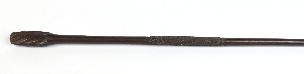 A tribal carved hardwood staff possibly Maori. With stylized centre band and with twist carved head,