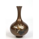 A Japanese bronze bottle vase with gold splashed decoration and engraved with a flower, 18cm.