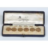 A cased set of six Edwardian 9 carat gold planished buttons by Cornelius Saunders and Francis