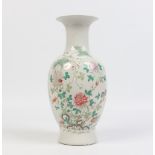 A Chinese famille rose baluster vase. Painted with peonies and foliage issuing from a rock. Feint