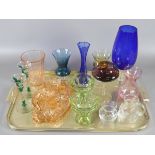 A collection of glasswares including coloured examples and dressing table set.