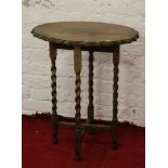 An oak barleytwist occasional table with scalloped top.