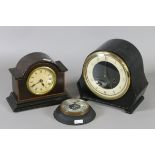 Two mantel clocks, one chiming on a gong, along with a barometer.