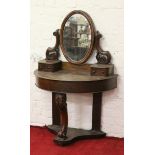 A Victorian mahogany Duchess dressing table with oval mirror and raised on a carved scrolling