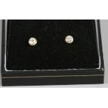 A pair of 18ct gold earrings each set with a solitaire brilliant cut diamond, approximately 0.