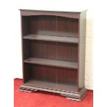 A mahogany veneered open bookcase.