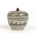 An antique Eastern lidded earthenware pot and cover decorated in underglaze blue, 9cm. Condition