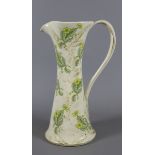 A strap handled jug decorated with flowers.