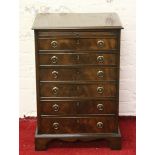 A mahogany six drawer collectors chest with velvet lined drawers and slide.