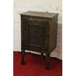 An antique continental oak side cabinet inlaid and carved with thistles to the door (AF).