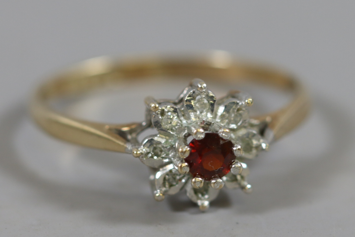 A 9 carat gold garnet and diamond cluster ring, size O.