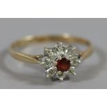 A 9 carat gold garnet and diamond cluster ring, size O.