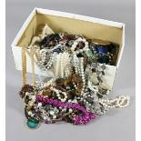 A box of assorted costume jewellery mostly beads and a resin cherubs.