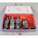 A Chinese silk mounted box containing souvenir figures of the terracotta army.