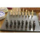 A decorative chess board with glass top along with composite pieces.