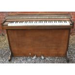 A wooden cased cottage piano.