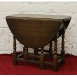 An Old Charm carved and turned oak occasional drop leaf table.