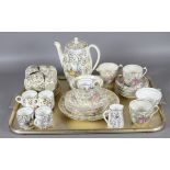 A collection of tea and coffee wares all decorated in a crinoline lady design.