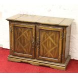 A parquetry inlaid oak sideboard with fold out top and incorporating a cutlery drawer.