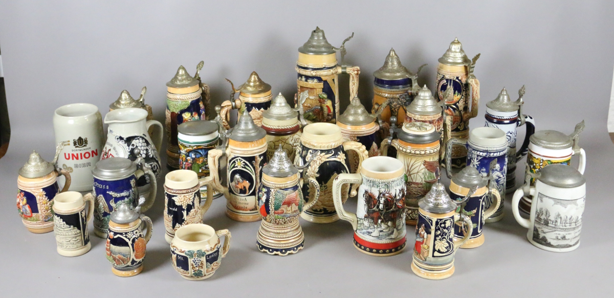 A collection pottery steins to include pewter covered and musical examples.