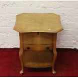 A walnut single drawer work table raised on cabriole legs.