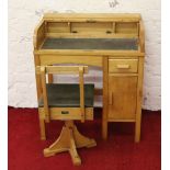 A childs roll top desk and swivel chair.