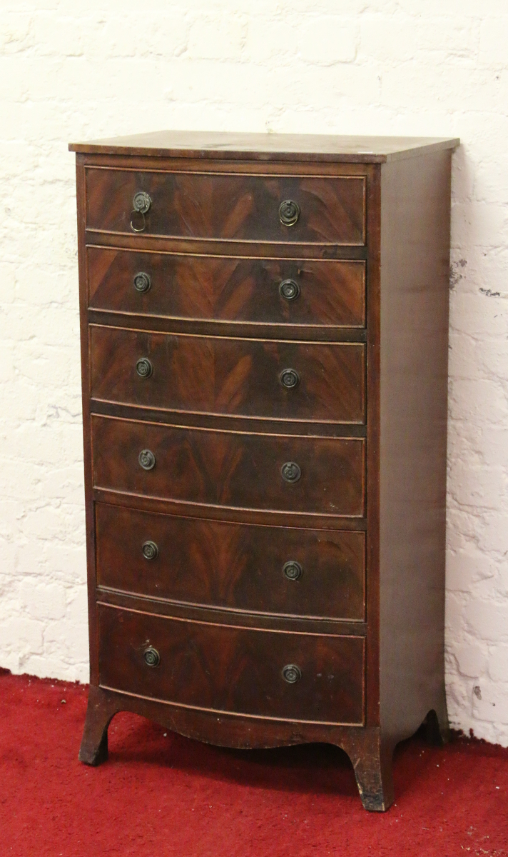 A mahogany six drawer bow front Wellington chest raised on splay bracket supports.