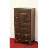 A mahogany six drawer bow front Wellington chest raised on splay bracket supports.