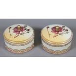 Two blush ground lidded powder bowls decorated with flowers.