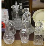 A collection of cut glass decanters along with a biscuit barrel.