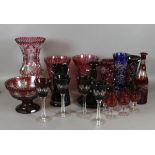 A collection of cut faceted and flashed glass items to include ewer, centrepiece, vases etc.