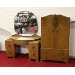 An Art Deco two part walnut bedroom suite comprising tallboy and dressing table.