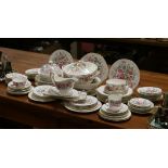 A comprehensive Paragon china dinner service decorated with trailing bands of roses,