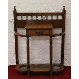 A Victorian walnut hallstand with single drawer raised on turned supports.