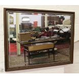 A large mahogany and parcel gilt framed bevel edged wall mirror