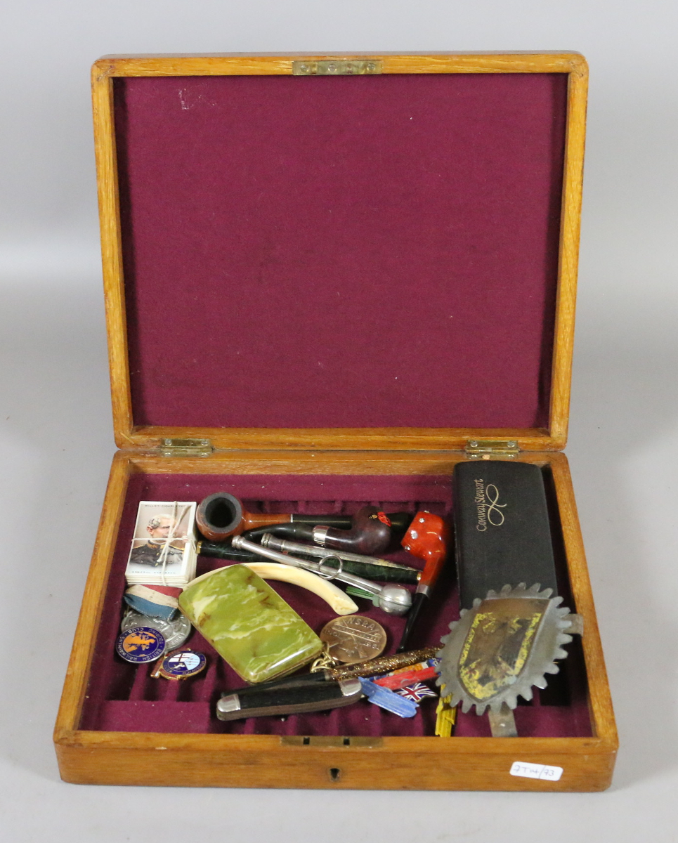 An oak cutlery box of mixed collectables including pipes, enamel badges,