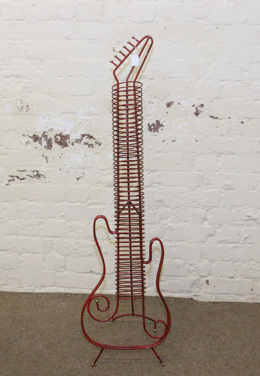 A metal guitar shaped CD rack.