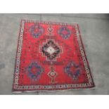 Arabic Style Wool Carpet with Central Lozinge Surrounded by Four Blue Lozinges with Red Background