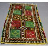 AN EASTERN RUG, central geometric lozenge design in geometric panels and stylised borders. 208cm x