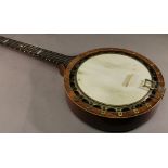 A BRASS MOUNTED ROSEWOOD BANJO of traditional form with brass mounts and boxwood stringing. 95cm